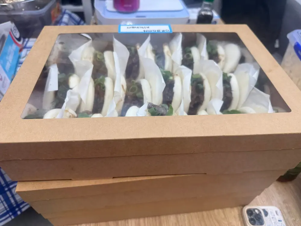 Boxes filled with individual steamed buns prepared for catering