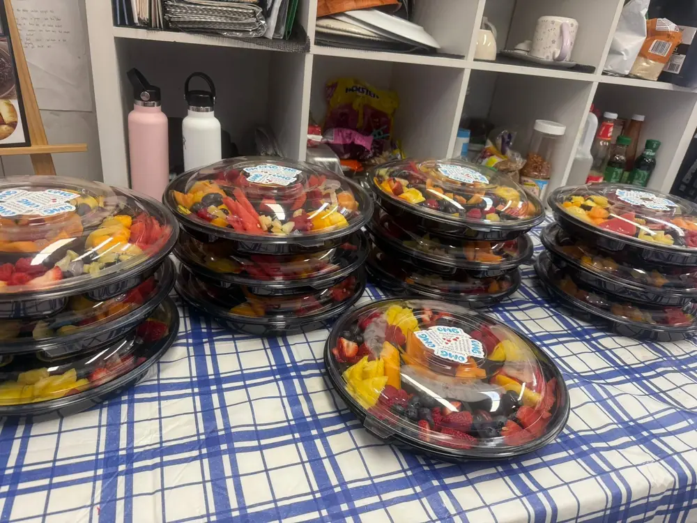 Rows of individual prepared salad bowls for a group