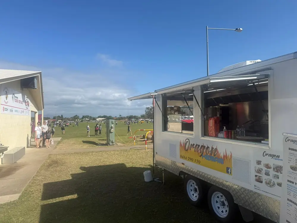 Oragon Kebab food truck set up beside an outdoor sports field